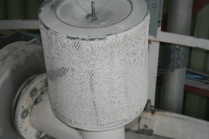 Ceci est l’élément filtrant à l’entrée d’une soufflante (blower) dédiée pour le transport de matière première dans des tuyaux. Ce dernier est complètement colmaté car le système n’est pas entretenu dans les règles de l’art. Le moteur électrique travaille plus fort qu’il ne le devrait et monte en ampérage tandis que la soufflante surchauffe faisant sortir l’huile de lubrification par son reniflard (vent). Comme le flot d’air dans les tuyaux de transport n’est plus suffisant, cela engendre des blocages et des arrêts de production.